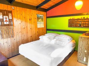 a bedroom with a bed with white pillows at Architectdesigned 1976 Summer House Near Beach in Store Fuglede