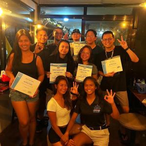 a group of people posing for a picture holding up certificates at Galera Lodge & Cafe in Puerto Galera