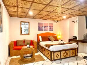 a bedroom with a large bed and a chair at Galera Lodge & Cafe in Puerto Galera +123 photos