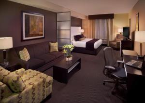 a hotel room with a couch and a bed at Best Western Premier Miami International Airport Hotel & Suites Coral Gables in Miami