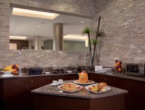 a kitchen with plates of food on a counter at Best Western Plus Miami Intl Airport Hotel & Suites Coral Gables in Miami