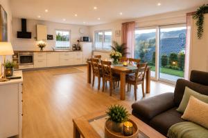 a kitchen and living room with a table and chairs at Panoramablick mit Premium-Wanderwegen vor der Haustür in Albstadt