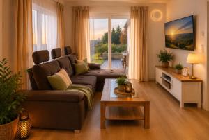 a living room with a couch and a table at Panoramablick mit Premium-Wanderwegen vor der Haustür in Albstadt