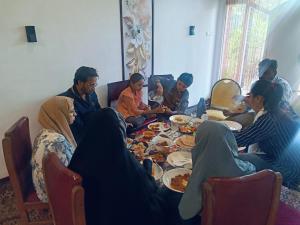 a group of people sitting around a table eating food at Hariparbatview in Srinagar