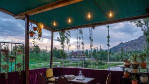 a restaurant with a view of the mountains at Hariparbatview in Srinagar
