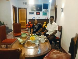 a man and a woman sitting at a table at Hariparbatview in Srinagar