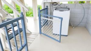 a washing machine on a porch with a blue door at Auki Ocean View in Auki +9 photos