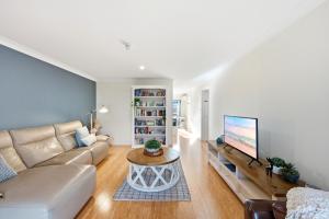 a living room with a couch and a tv at Stylish 2-Bed Apartment in Kingston in Kingston 