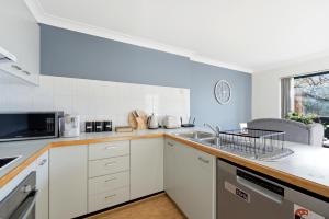 a kitchen with a sink and a microwave at Stylish 2-Bed Apartment in Kingston in Kingston 