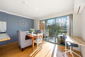 a living room with a table and chairs and a balcony at Stylish 2-Bed Apartment in Kingston in Kingston  +15 photos