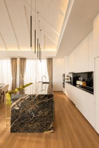 a kitchen with a marble counter top in a room at Le Da Villas 5BR Bang Tao Beach in Laguna Phuket