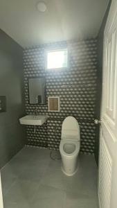 a bathroom with a toilet and a sink at Aysaii Home01 in Panwa Beach +4 photos