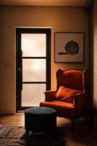 a living room with a chair and a window at Chloechen Home in Taitung City +8 photos