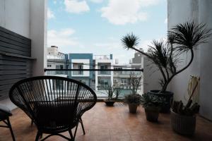 a balcony with a chair and potted plants at Chloechen Home in Taitung City