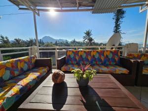 a patio with two couches and a table with a plant at Le Port Hotel in Fort Dauphin