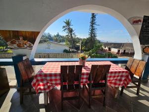 a table with a red and white checkered table cloth at Le Port Hotel in Fort Dauphin