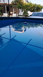 a reflection of a person in a pool of blue water at Villettine le Marie in Ricadi