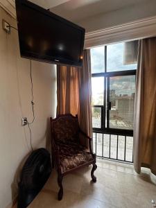 a living room with a chair and a large window at Hotel kristal in La Barca +33 photos