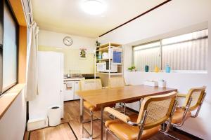 a kitchen and dining room with a table and chairs at Kokonimo Niiza in Niizo