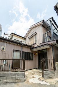 a house with a balcony on top of it at Kokonimo Niiza in Niizo