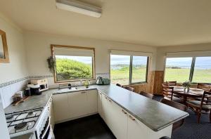 a kitchen with a sink and a stove top oven at Devils Gap in Currie