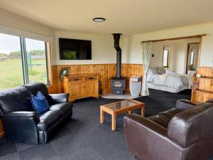 a living room with a couch and a bed at Devils Gap in Currie
