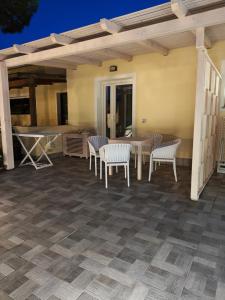 a patio with a table and chairs on a patio at Case Vacanza il Sole in La Maddalena