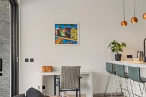 a living room with a table and a chair at Ocean View Apartment 384 Blue Bay in Dorp Sint Michiel +18 photos