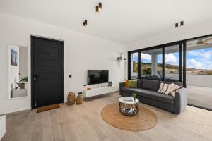 a living room with a couch and a table at Ocean View Apartment 384 Blue Bay in Dorp Sint Michiel