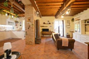 a large living room with a couch and a fireplace at Dimora Belfiore - Happy Rentals in Capolona +26 photos