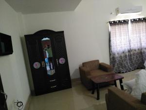 a living room with a mirror and a chair at Hotel Awadh Fort in Patna
