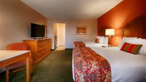 a hotel room with two beds and a flat screen tv at Best Western Plus A Wayfarer's Inn & Suites in Kingman