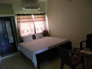 a small bedroom with a bed and a window at Hotel Awadh Fort in Patna