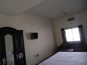a bedroom with a bed and a window at Hotel Awadh Fort in Patna