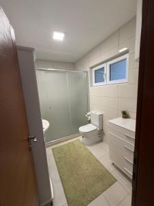 a bathroom with a toilet and a sink and a shower at Vila Sami in Bar