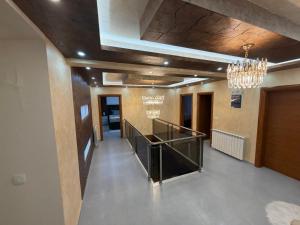 a hallway in a building with a chandelier at Vila Sami in Bar