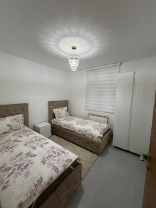 a bedroom with two beds and a refrigerator at Vila Sami in Bar