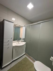 a bathroom with a sink and a toilet and a mirror at Vila Sami in Bar