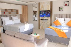 a hotel room with a bed and a couch at Viva Guest House in Trevallyn +72 photos