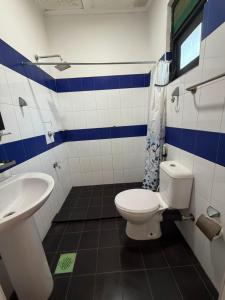 a bathroom with a toilet and a sink at Terrel Residencies Gal Oya in Ampara