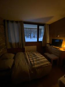 a bedroom with a bed and a desk and a window at Welcome to Star Vars! in Vars