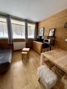 a living room with a table and a wooden wall at Welcome to Star Vars! in Vars
