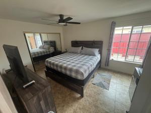 a bedroom with a bed and a tv and a mirror at King's Suite Escape in Ontario