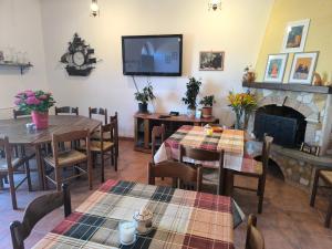 a dining room with tables and a fireplace at BUONUMORE-la QUIETE in Acquapendente