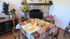 a table with a table cloth with fruit on it at BUONUMORE-la QUIETE in Acquapendente