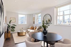 a living room with a table and a couch at Second Storey at Kew in Kew Bridge