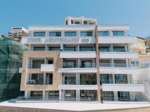 a building with a sign for the hotel madhuban at Hotel Mediterraneo Liman in Ulcinj +57 photos