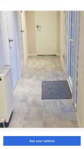 an empty hallway with a door and a rug at Lakeside in Carrowmoreknock