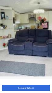 a blue couch sitting in a living room at Lakeside in Carrowmoreknock