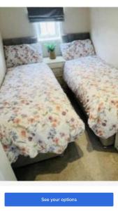 two beds sitting next to each other in a bedroom at Lakeside in Carrowmoreknock